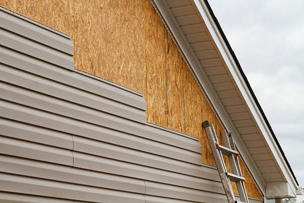 Professional Storm Damage Siding Repair technician working in Jordan, MN